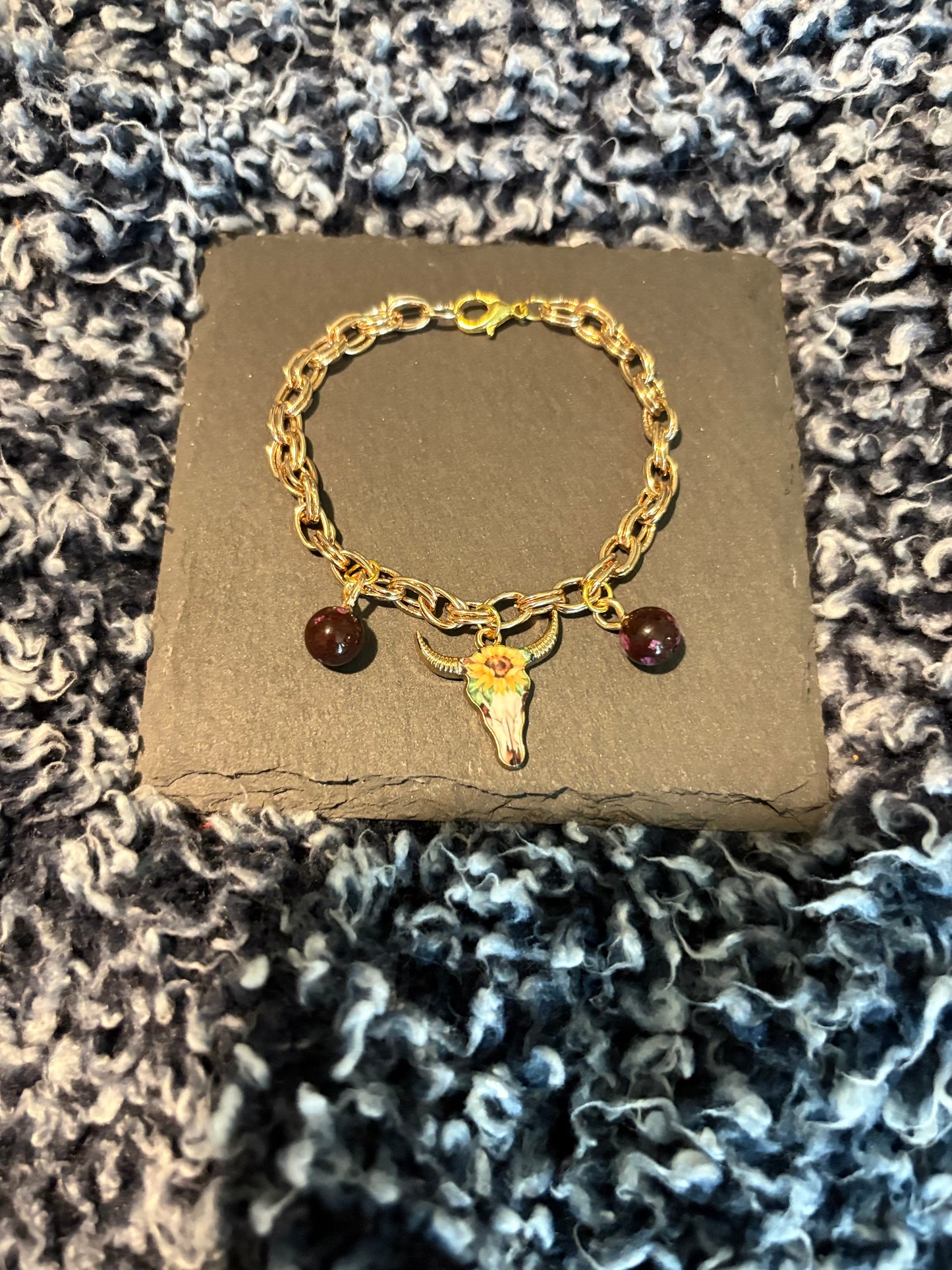 Gold bracelet with bull and almandine garnet